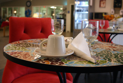 A cozy cafe setting with a coffee cup and napkin on a beautifully decorated table.