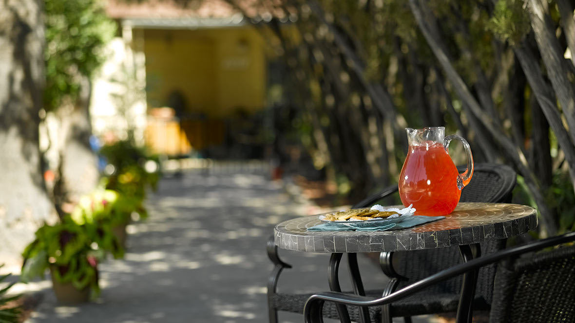 A sunny outdoor patio with a refreshing drink on the table.