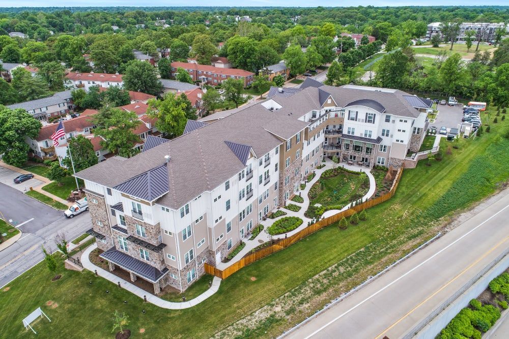 Aerial view of a suburban residential apartment complex surrounded by greenery.