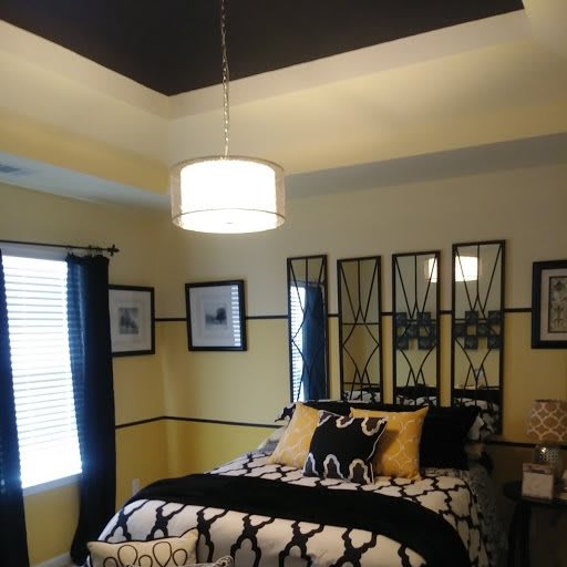 A modern bedroom with stylish decor and ambient lighting.