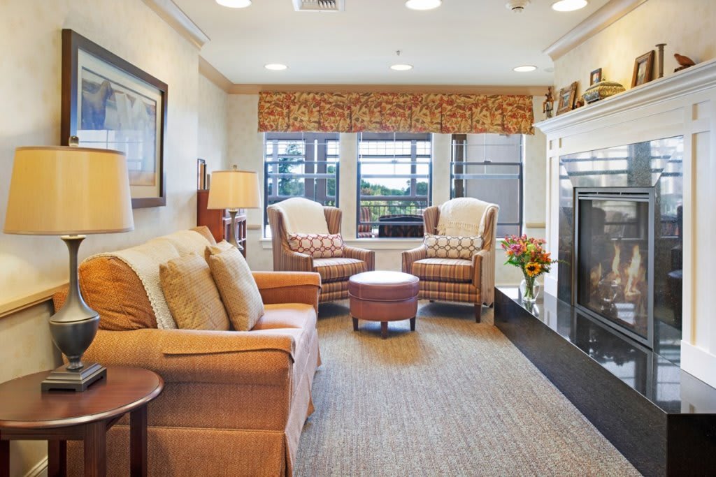 A cozy living room with comfortable seating and a warm fireplace.