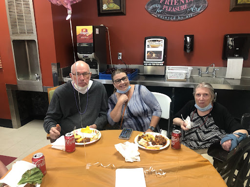 A cozy gathering at a dining table, enjoying a meal together.