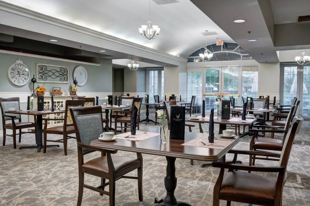 An empty restaurant dining area with neatly arranged tables and chairs.