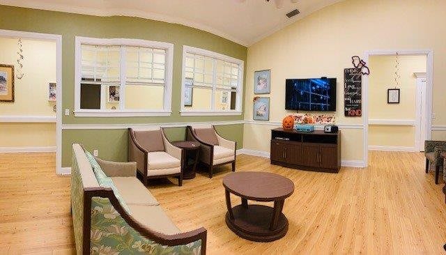 A cozy waiting room with comfortable seating and a television.