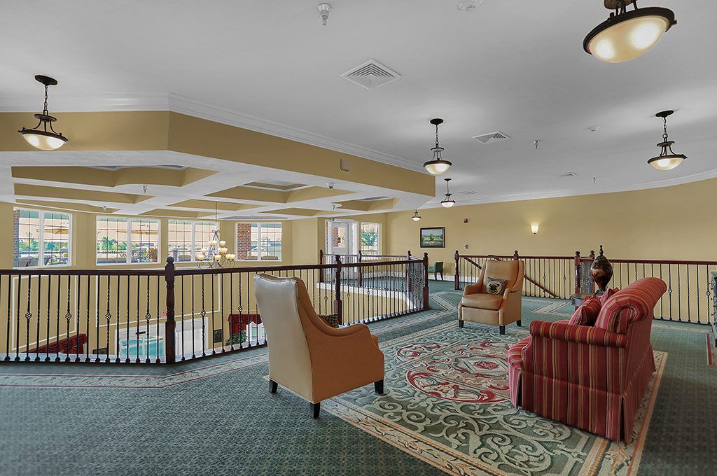 A cozy indoor lounge area with comfortable seating and a view over a balcony.
