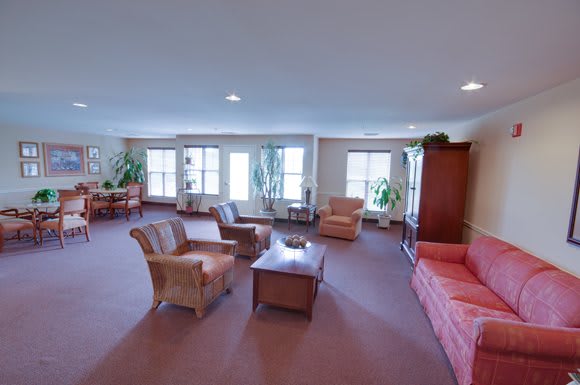 A spacious living room with comfortable seating and large windows.