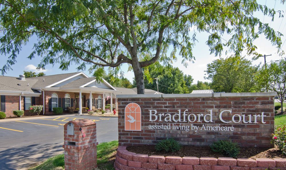 A view of a retirement community with a sign reading 'Bradford Court senior living by Americare.'