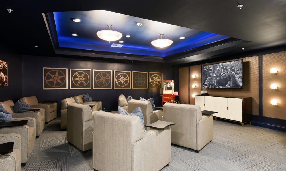 A modern home theater with plush seating and ambient lighting.