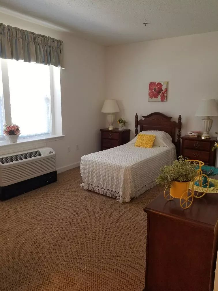 A cozy bedroom with a single bed and traditional furnishings.