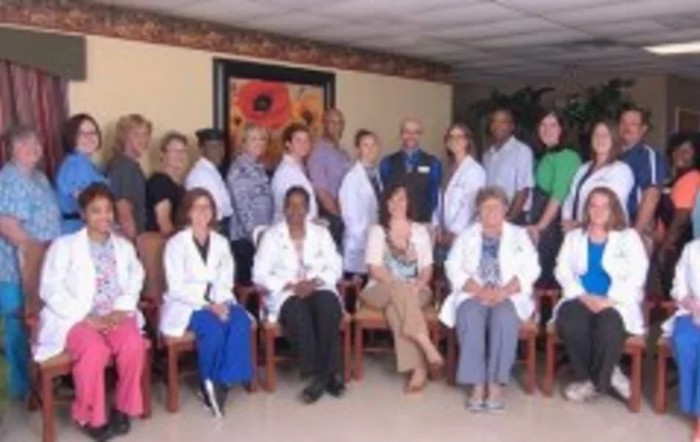 A group photo of medical staff in a waiting room.