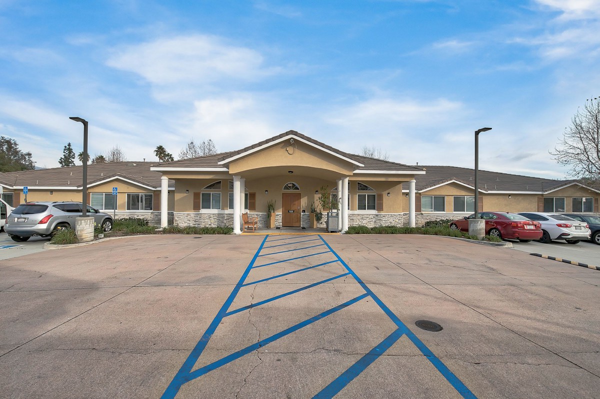 A single-story building with a welcoming entrance and accessible parking spaces in front.