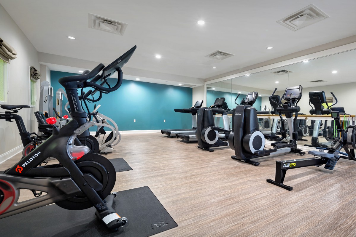 A well-equipped gym featuring stationary bikes and treadmills.