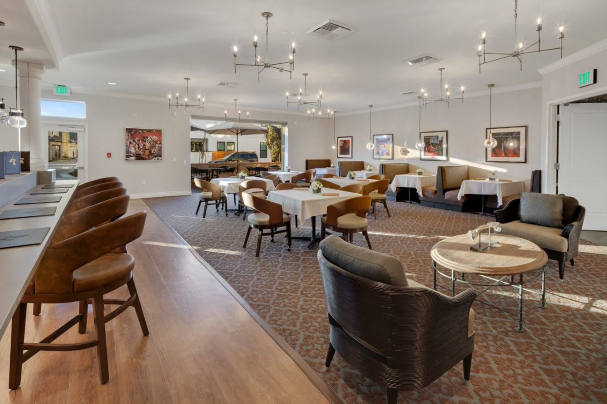 A modern, elegantly designed restaurant dining area featuring comfortable seating and stylish lighting fixtures.