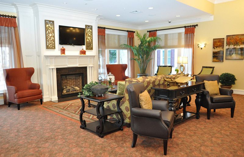 A cozy living room featuring a fireplace, comfortable seating, and elegant decor.