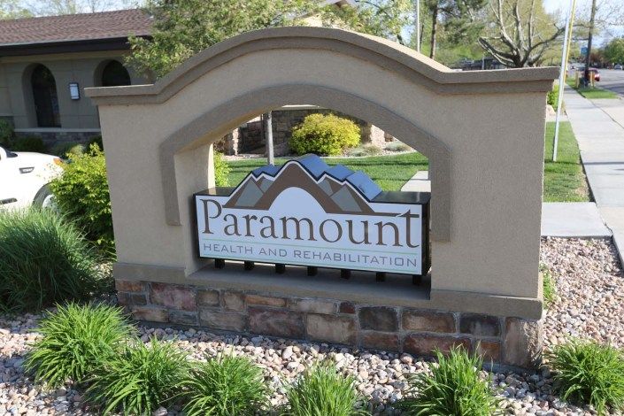 Entrance sign for the Paramount community surrounded by landscaping.