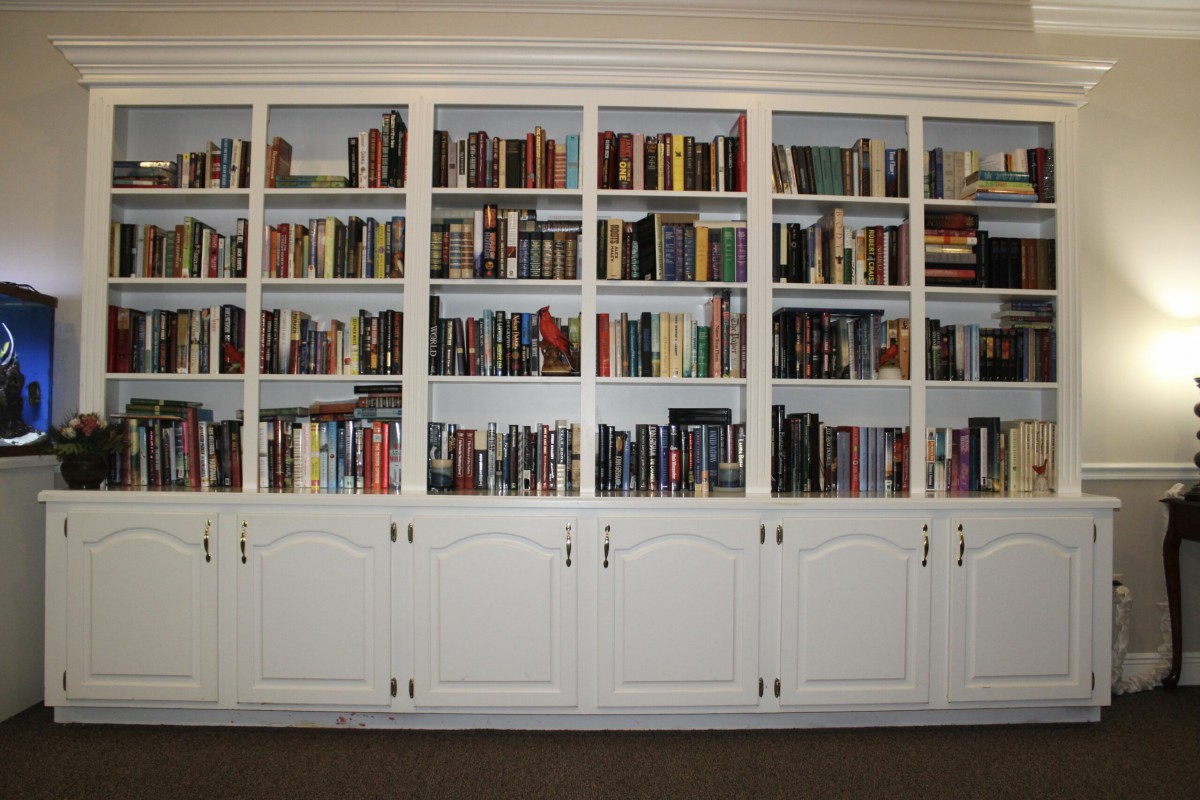 A large built-in bookshelf filled with a variety of books.