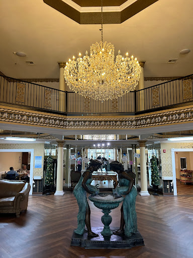 An elegant lobby featuring a stunning chandelier and stylish decor.