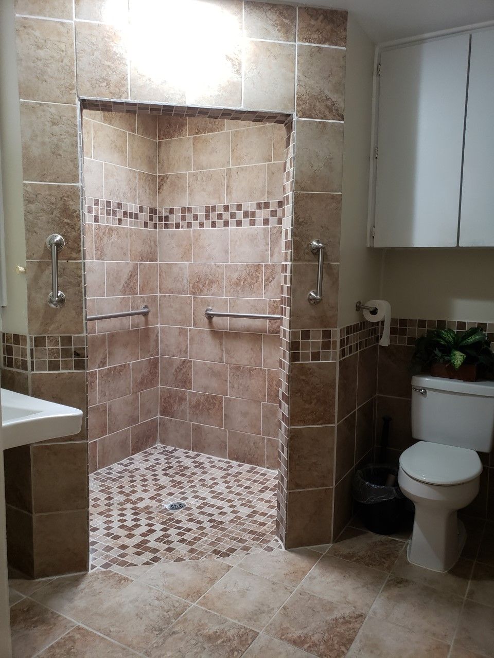 A modern bathroom featuring a walk-in shower with tile design.