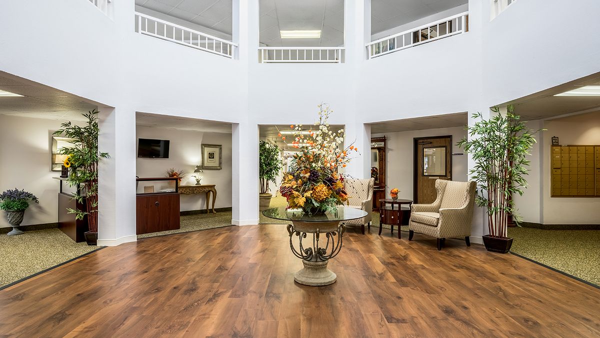 A beautifully decorated lobby with floral arrangements and comfortable seating.