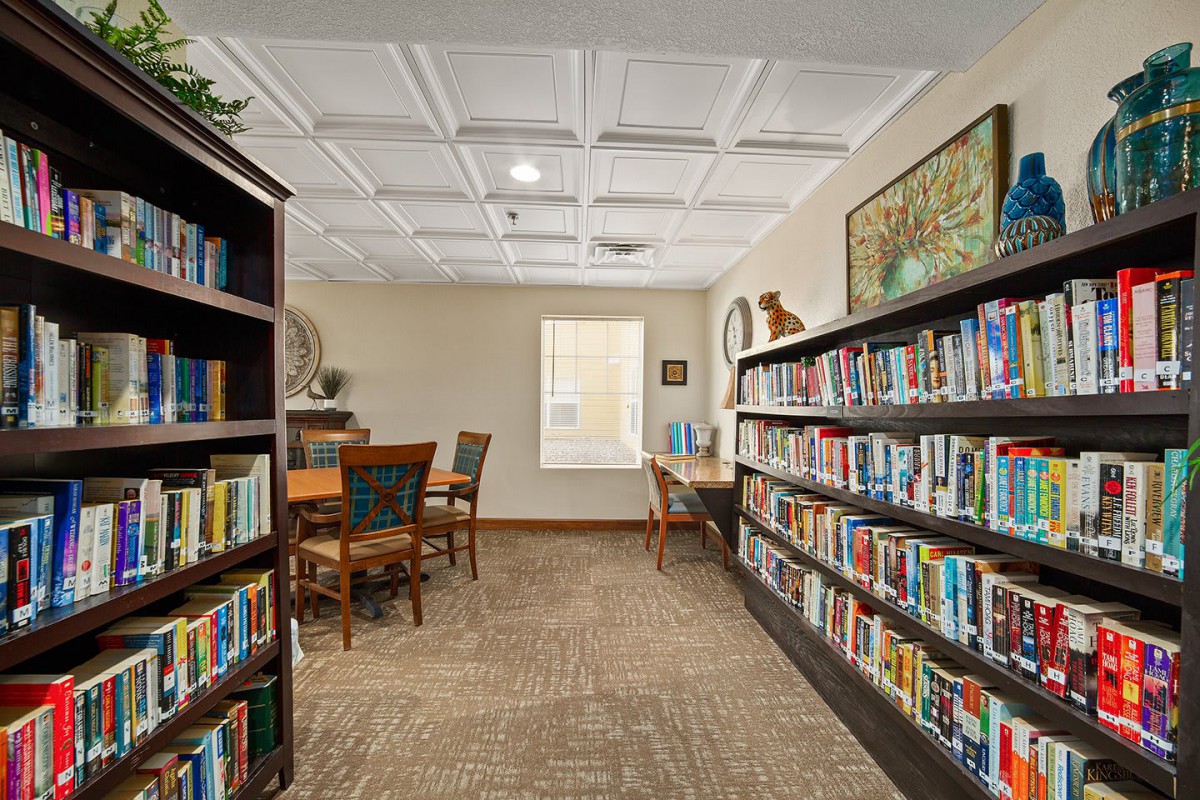 A cozy library space with bookshelves and a seating area for reading.