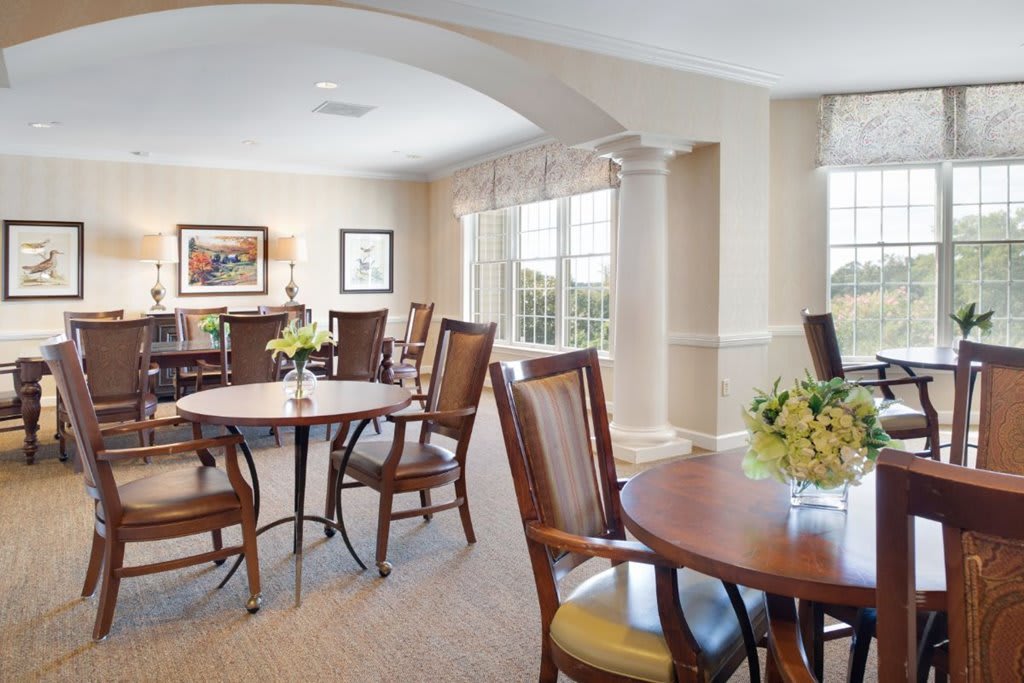 A bright and spacious dining area with elegant furniture and large windows.