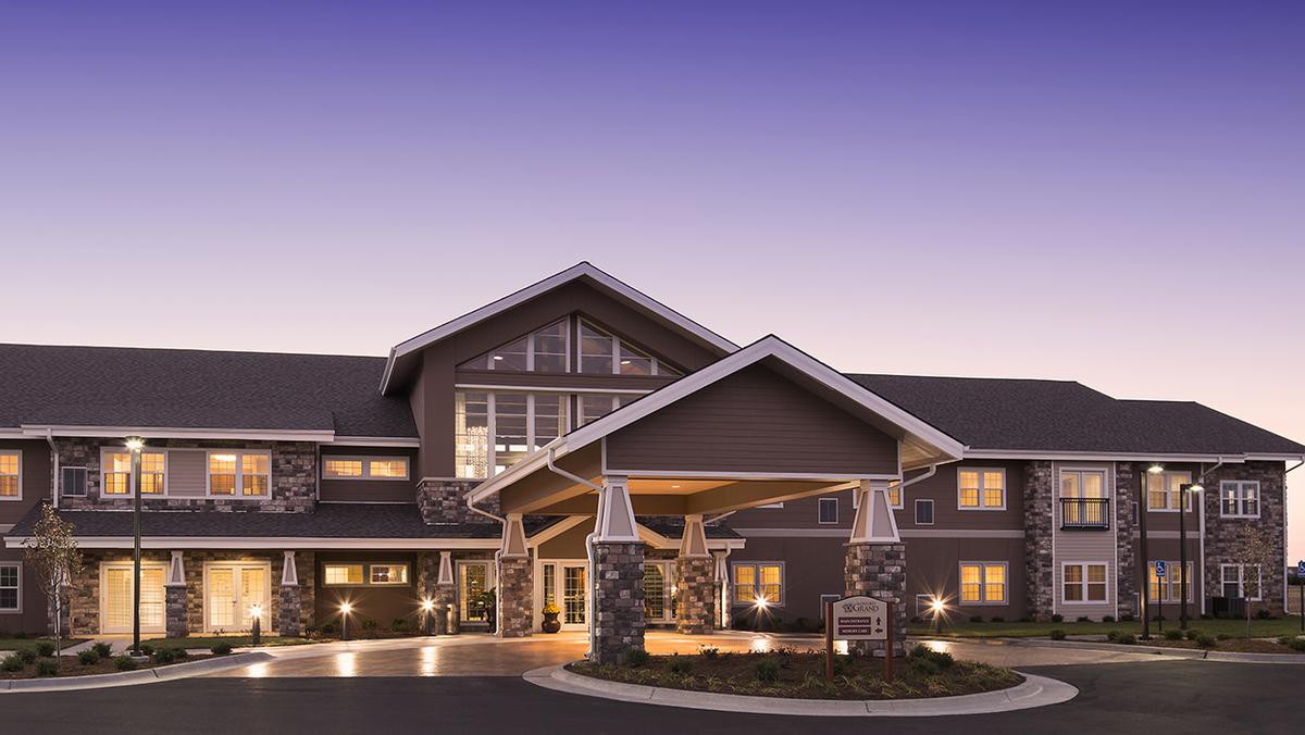 A modern, well-lit building with a welcoming entrance during evening hours.