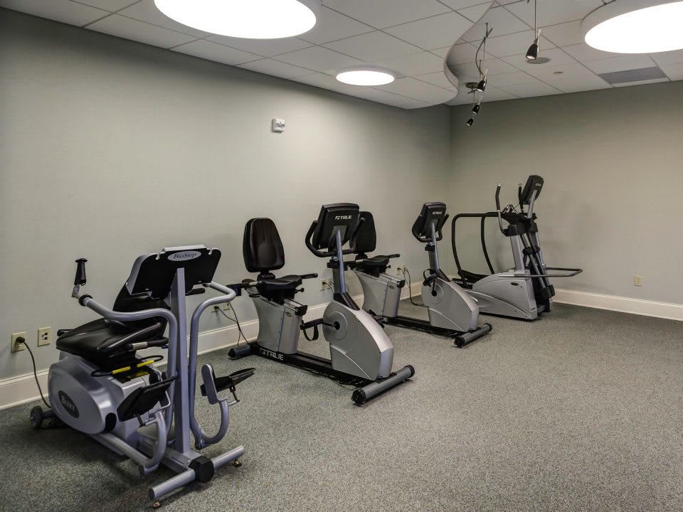 A fitness room equipped with stationary bikes and treadmills.