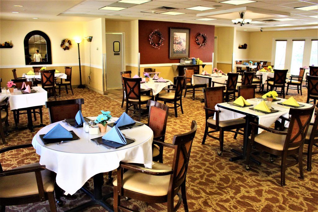 An empty restaurant dining area with neatly arranged tables and chairs.