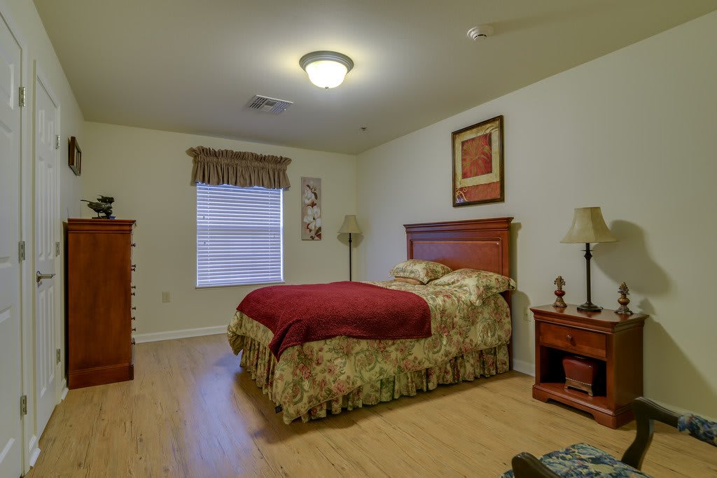 A cozy bedroom with wooden furniture and a large bed.