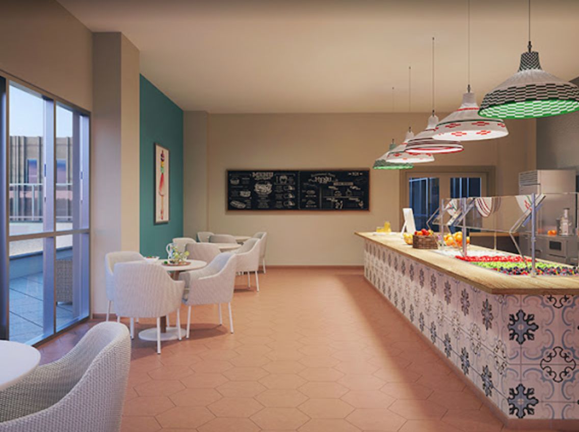 A cozy cafe interior featuring a seating area and a stylish counter with decorative lighting.