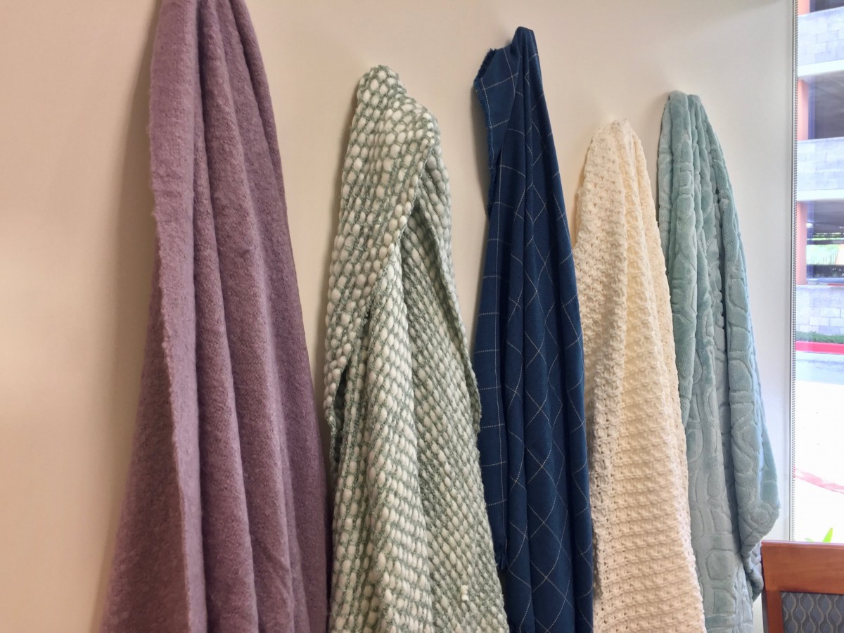 Colorful towels hanging on a rack.