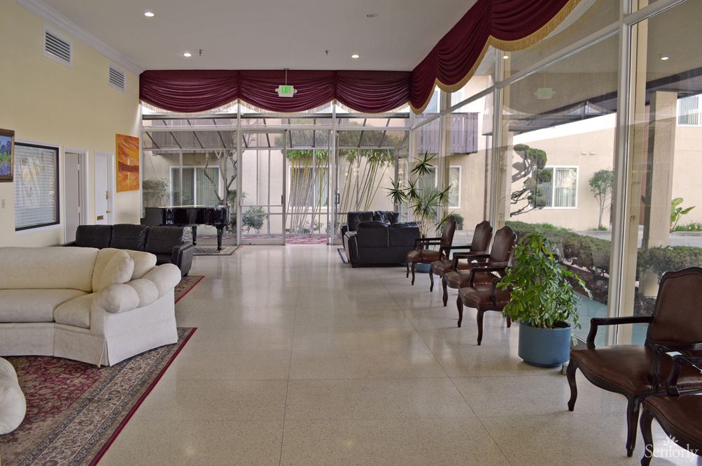 A spacious lobby featuring comfortable seating and large windows that allow natural light to fill the room.
