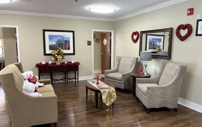 A cozy living room with comfortable seating, wall art, and decorative elements.