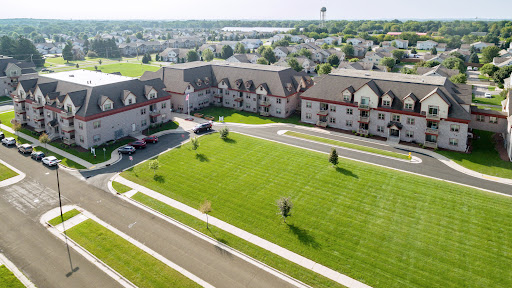 Aerial view of a residential complex featuring manicured lawns and well-maintained buildings.