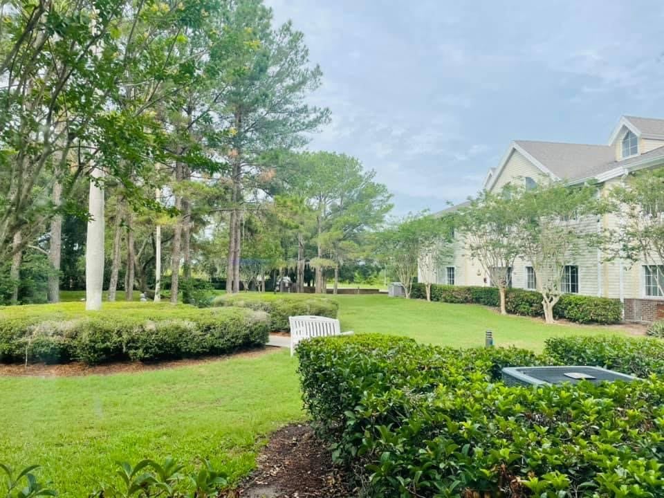 A serene residential area with well-maintained gardens and lush greenery.