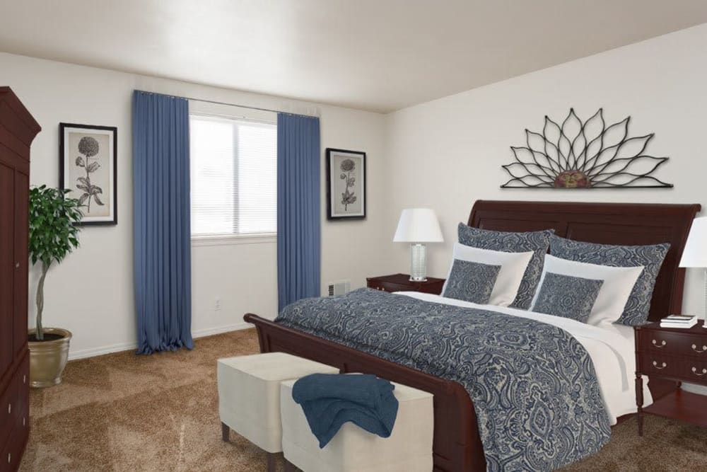 A cozy bedroom with blue accents and tasteful decor.