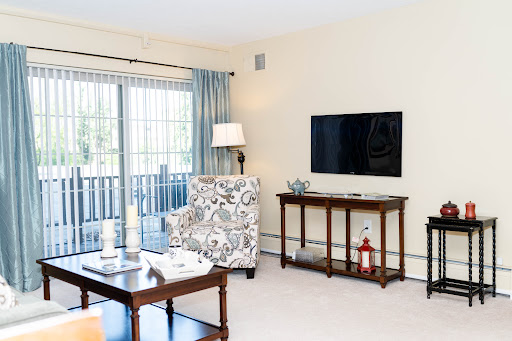 A cozy living room featuring a modern design, complete with a television, comfortable seating, and ample natural light.
