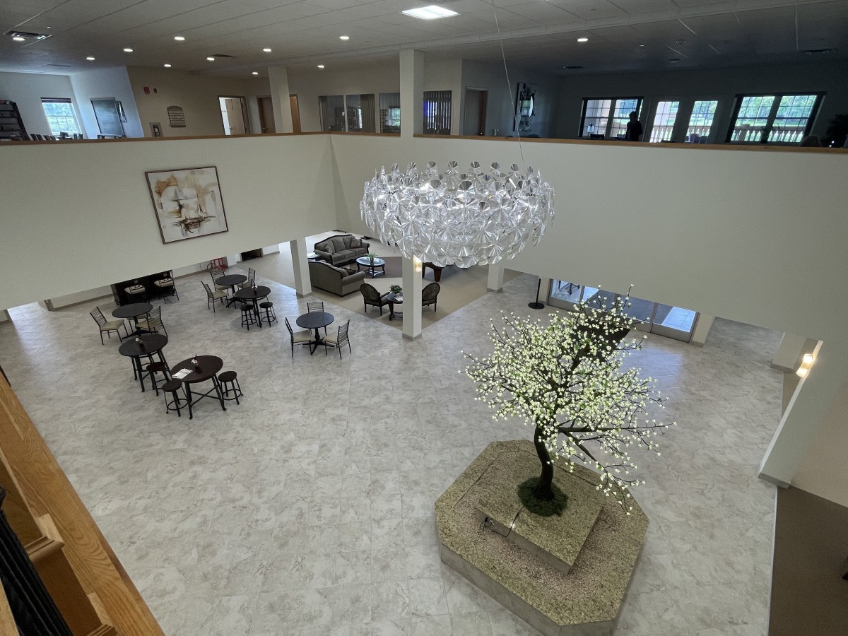 Spacious and modern lobby area featuring elegant furniture and decorative lighting.