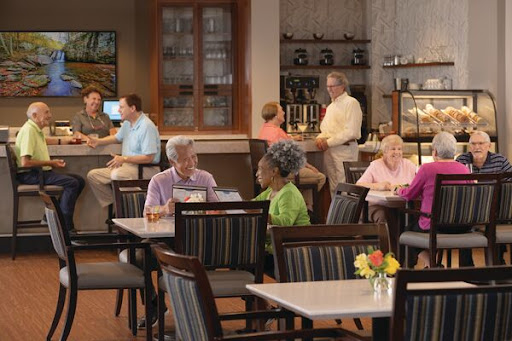 A vibrant cafe scene featuring seniors enjoying their meals and engaging in conversation.