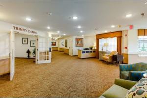 A spacious and well-lit lobby area with comfortable seating and a reception desk.