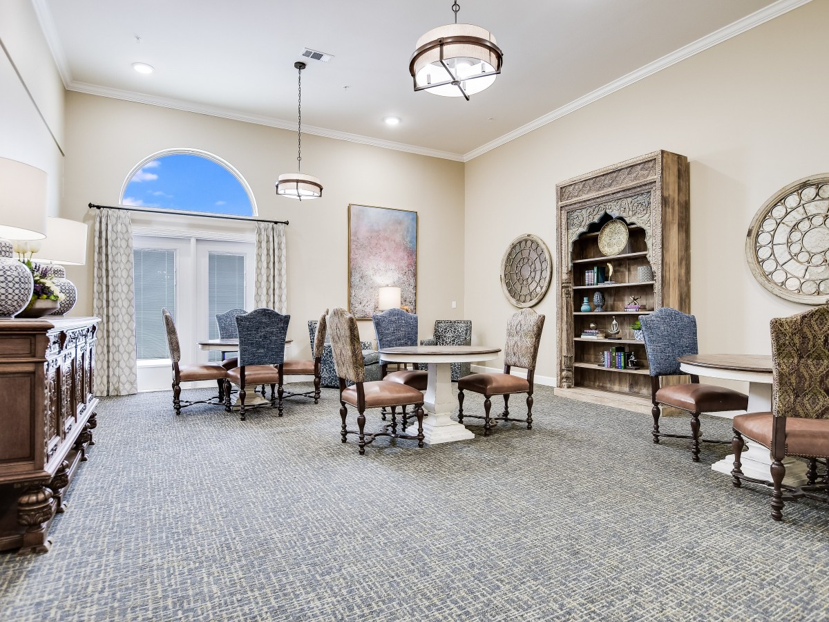 A spacious dining area with elegant furniture and decor.