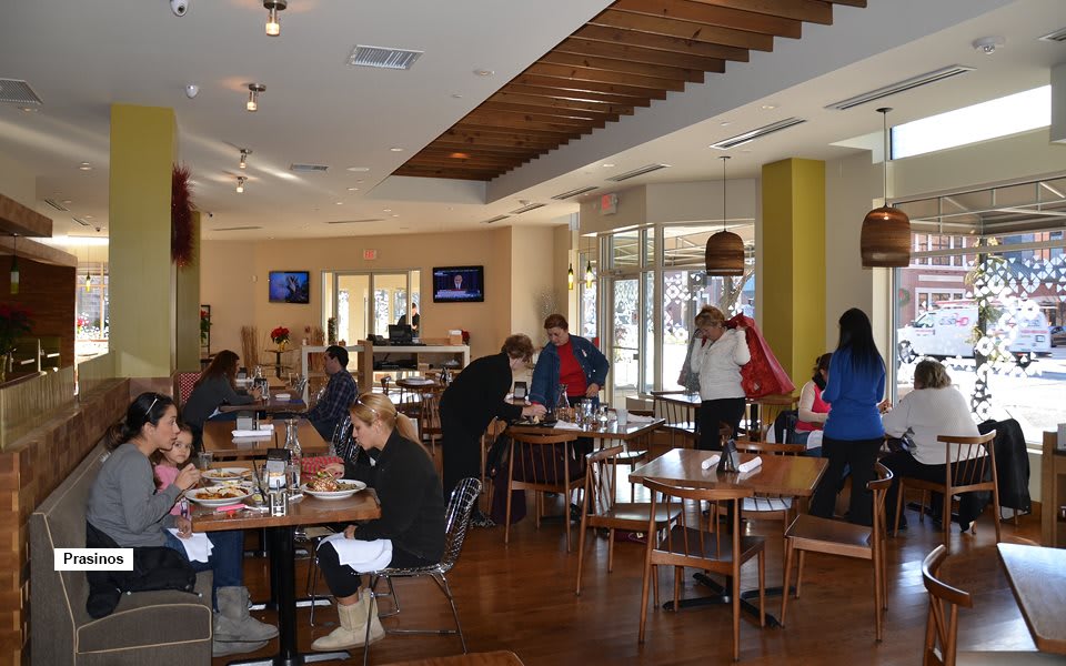 People dining inside a restaurant with modern interior design.