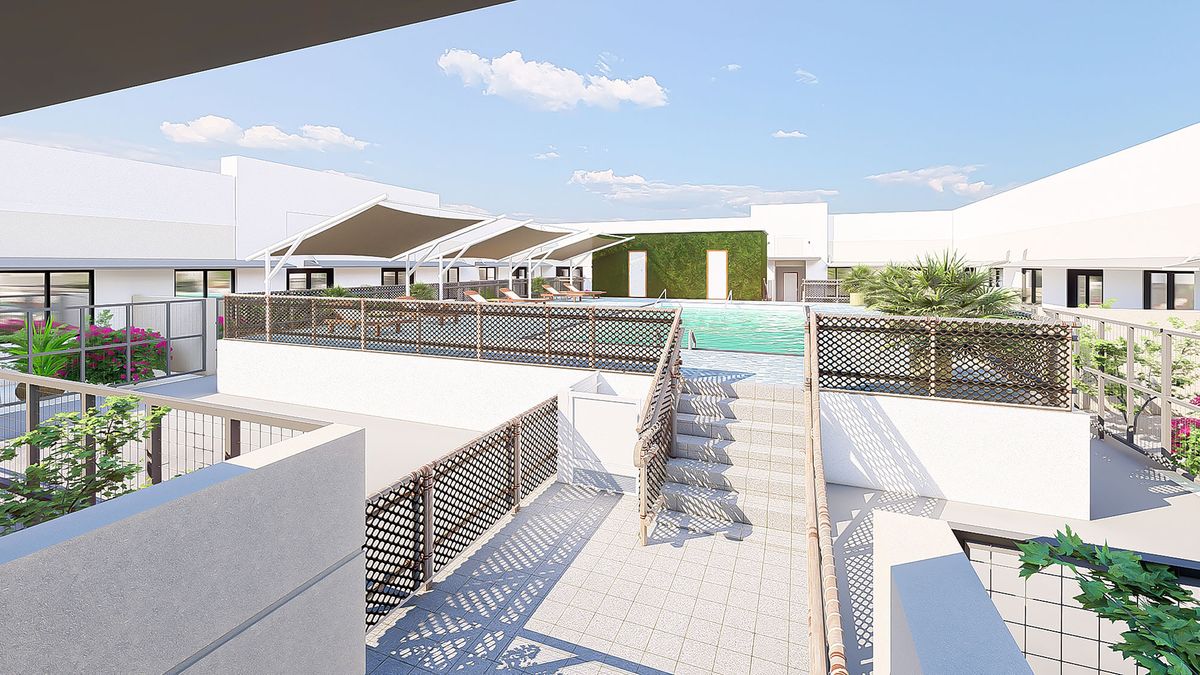 A modern rooftop area featuring a swimming pool and sleek architectural elements under a clear blue sky.