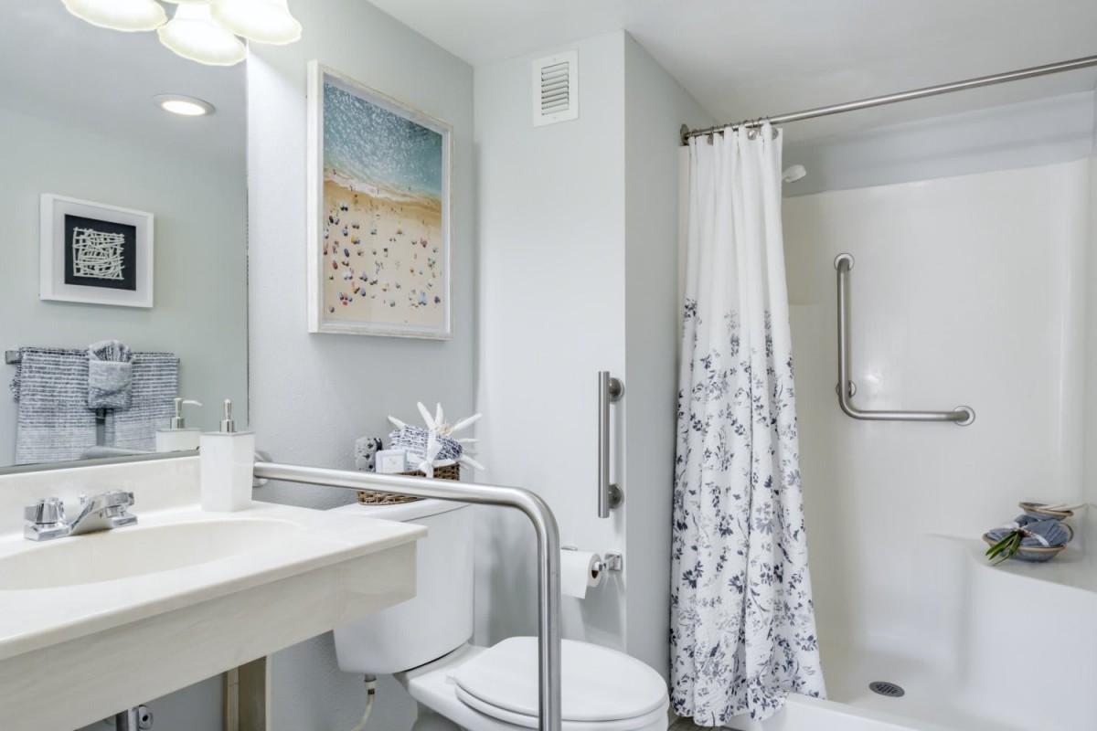 Modern bathroom with a shower, sink, and stylish decor.