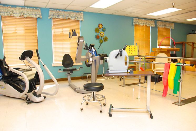 A well-equipped rehabilitation and exercise room with various fitness machines.