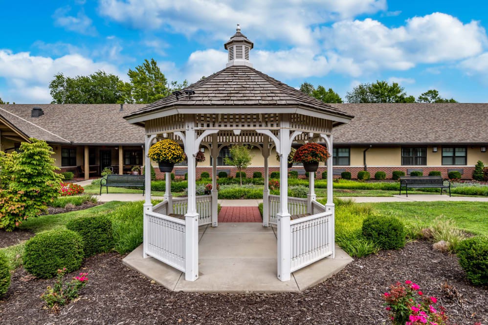A picturesque white gazebo set amidst a lush garden.