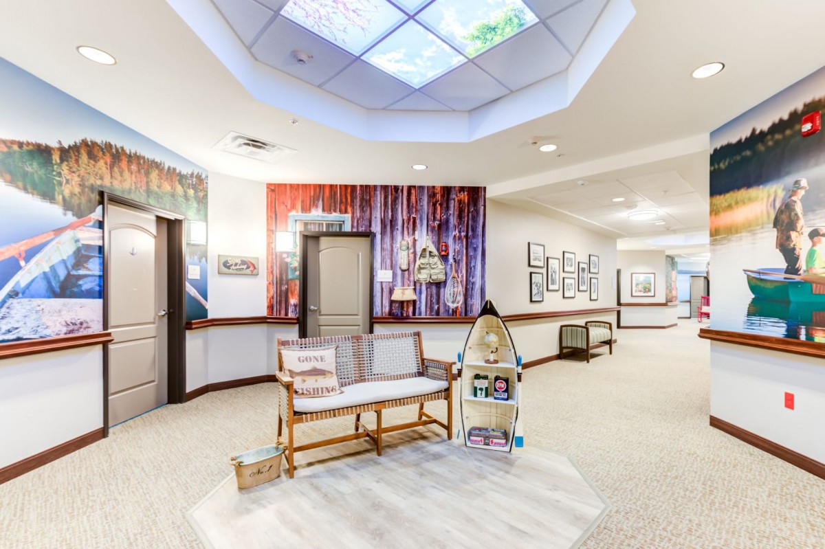 A bright and welcoming hallway featuring a cozy seating area with decorative elements and artwork on the walls.