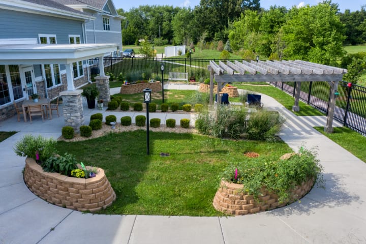Beautifully landscaped garden with a lush lawn, pathways, and various plants.