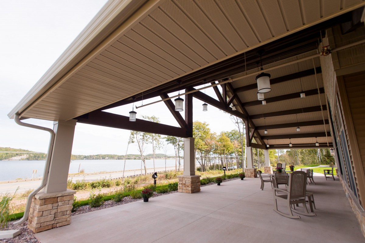 A spacious patio with outdoor seating overlooking a serene lake.