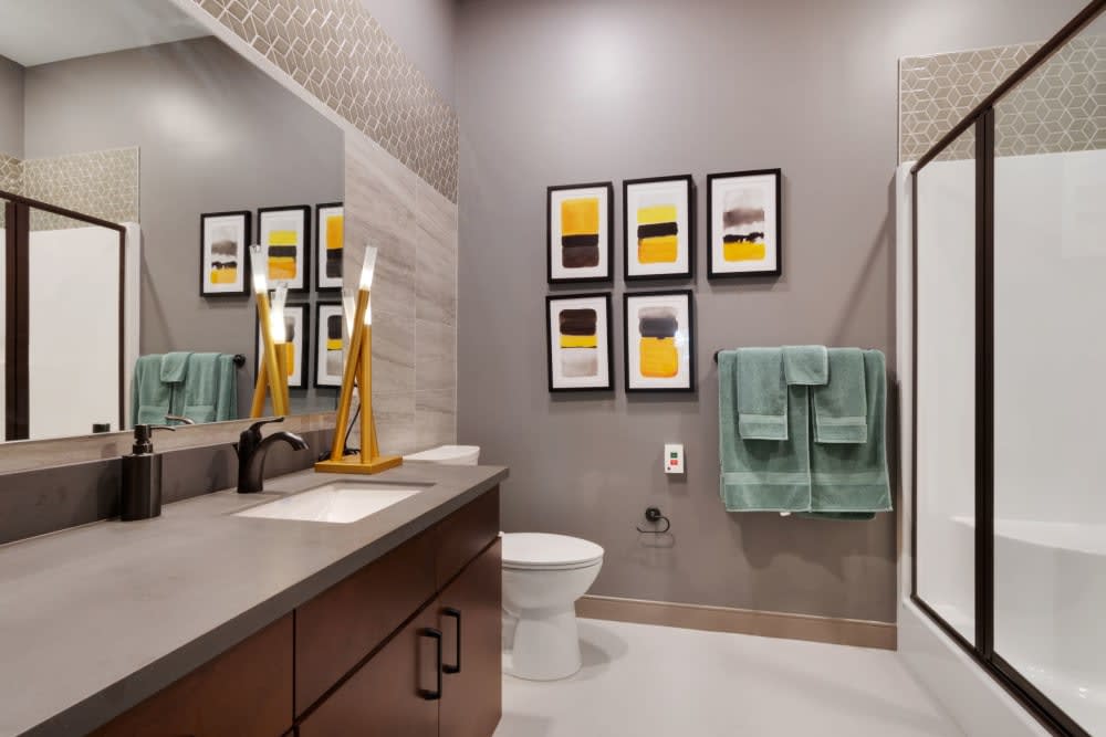 Modern bathroom with contemporary decor and framed artwork.